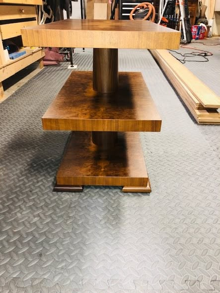 Three-tier side table with burl walnut top surfaces in a four-way book-match pattern, vertical-grain walnut edge banding, and a turned walnut center column, finished in matte conversion varnish.