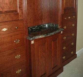 Detail of dovetail drawers and flower-inlaid rosettes on cherry cabinet