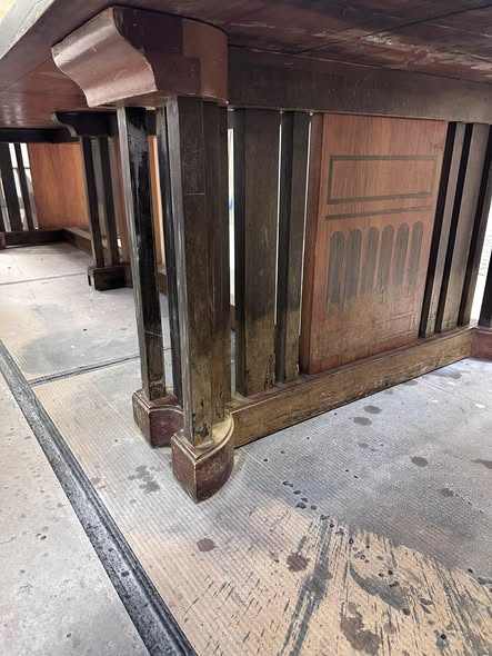 Underside view of the historic Nara table base showing the original structure and inlay areas being restored during the restoration process.