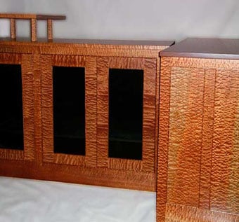 Matched pair of Pommelle Sapele audio cabinets flanking a fireplace