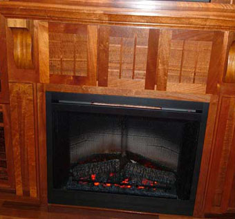 Crowned mantel top with corbels above the fireplace and DVD pull-outs