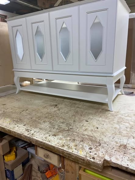 Four-door extra-white vanity cabinet with double-bead door frames, diamond-pattern panels with proud bead wrapping the inside of each diamond, frosted glass, and hand-shaped cabriole feet